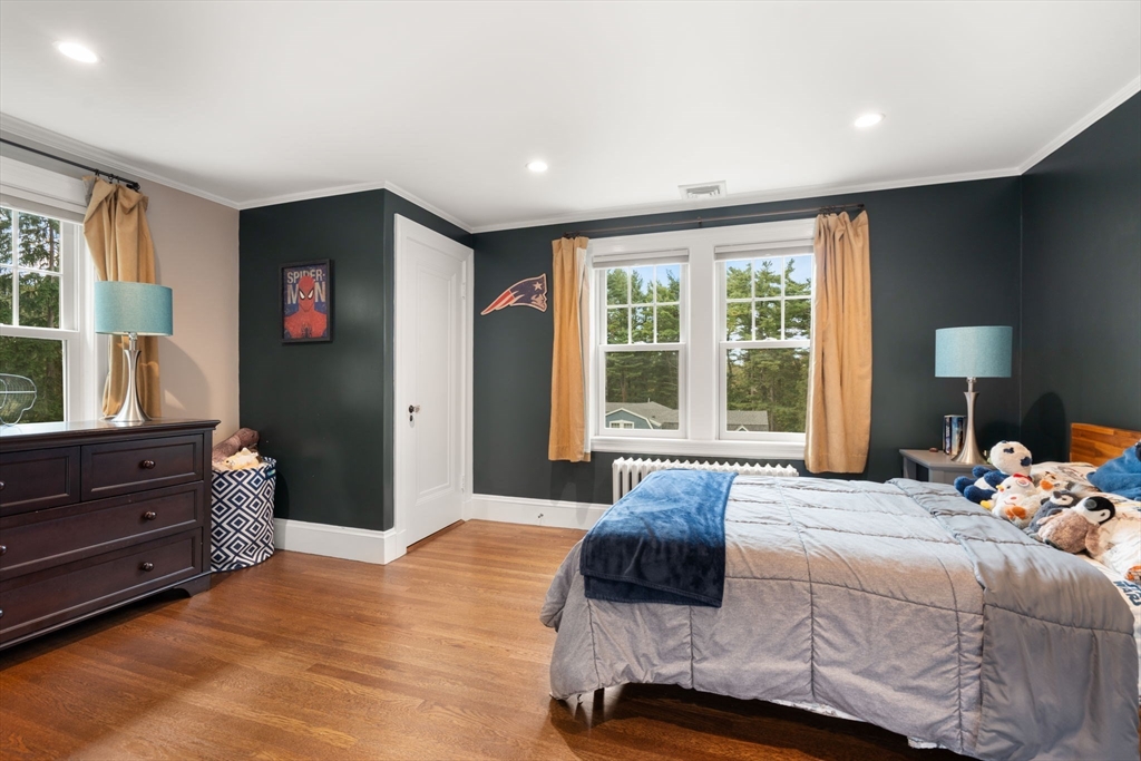 61 Silver Hill Road Weston, MA 02493 - Photo 24 of 39 a bedroom with a bed and wooden floor