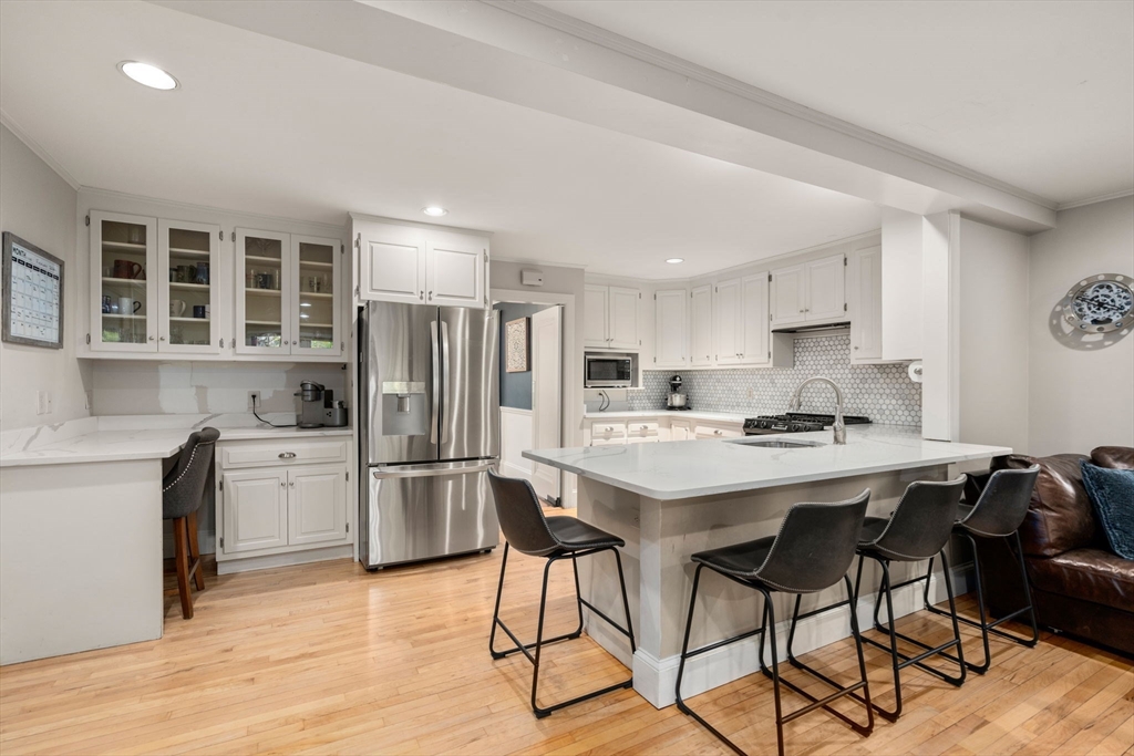 61 Silver Hill Road Weston, MA 02493 - Photo 8 of 39 a kitchen with refrigerator cabinets and wooden floor