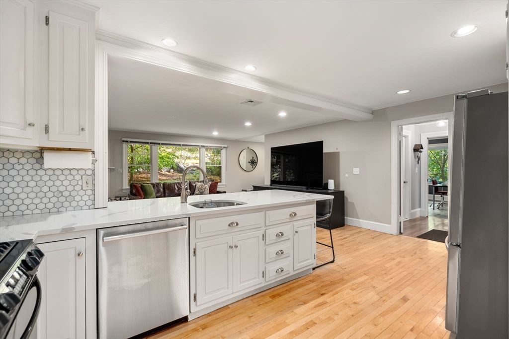 61 Silver Hill Road Weston, MA 02493 - Photo 10 of 39 a large white kitchen with sink and white cabinets