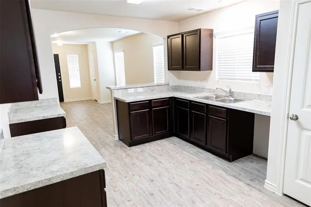 a kitchen with a sink and a mirror