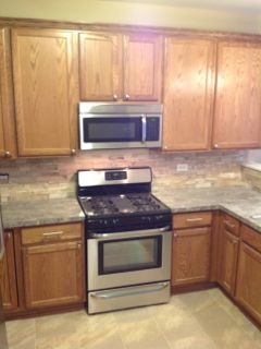 3144 Falling Waters Lane, Unit 3142 Lindenhurst, IL 60046 - Photo 14 of 16 a kitchen with granite countertop a stove and a sink