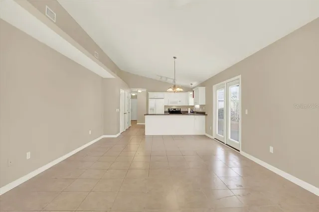 a view of a kitchen with a sink and dishwasher a refrigerator with wooden floor