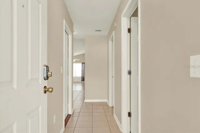a view of a hallway with wooden floor and closet
