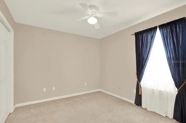 an empty room with windows and entrance