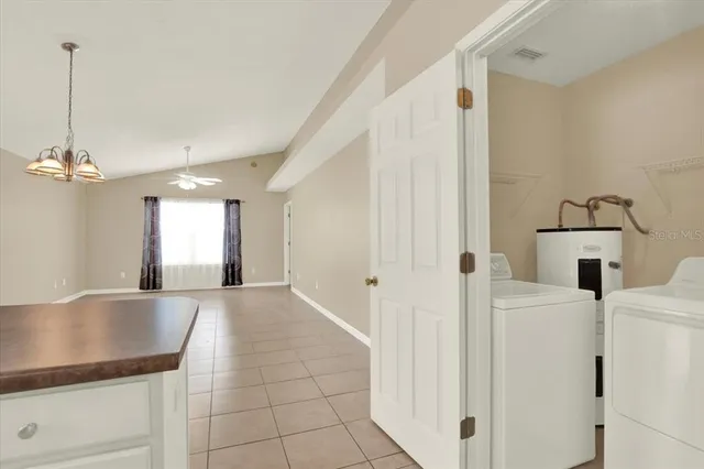 a view of a kitchen with a sink dishwasher and a fireplace
