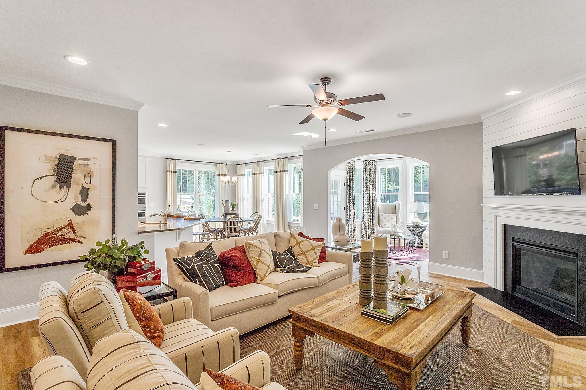 243 Oak Branch Trail Garner, NC 27529 - Photo 14 of 29 a living room with furniture a fireplace and a flat screen tv