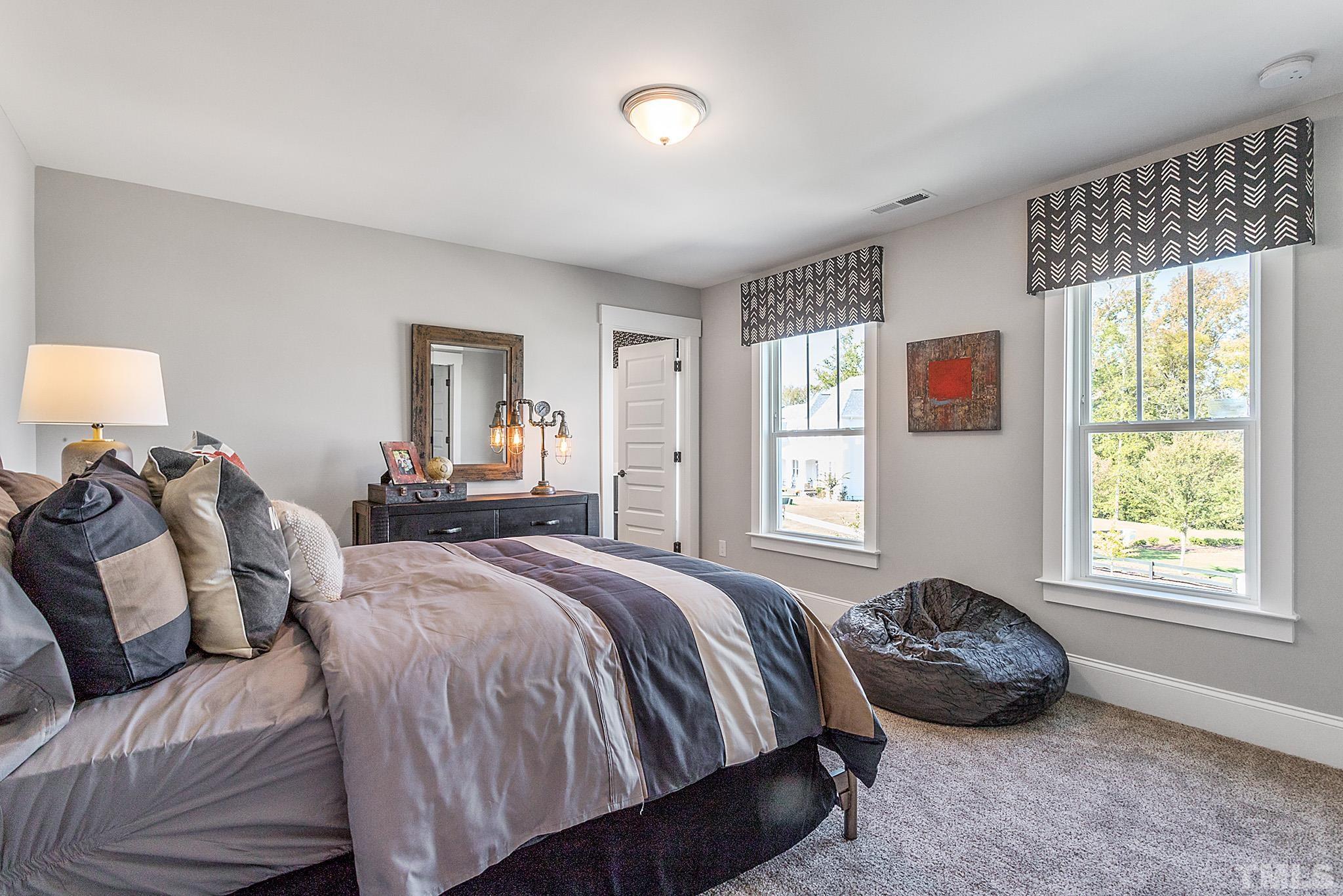 243 Oak Branch Trail Garner, NC 27529 - Photo 20 of 29 a bedroom with a bed and a window
