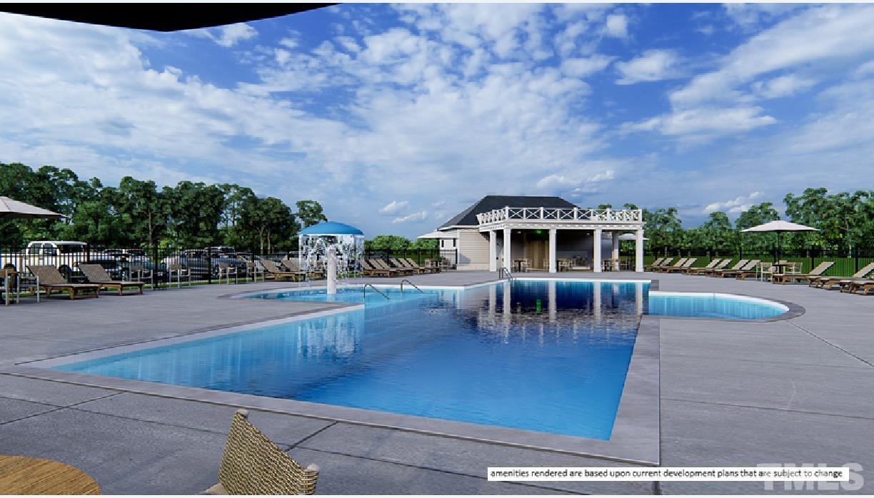 243 Oak Branch Trail Garner, NC 27529 - Photo 25 of 29 a view of a swimming pool with lawn chairs and plants