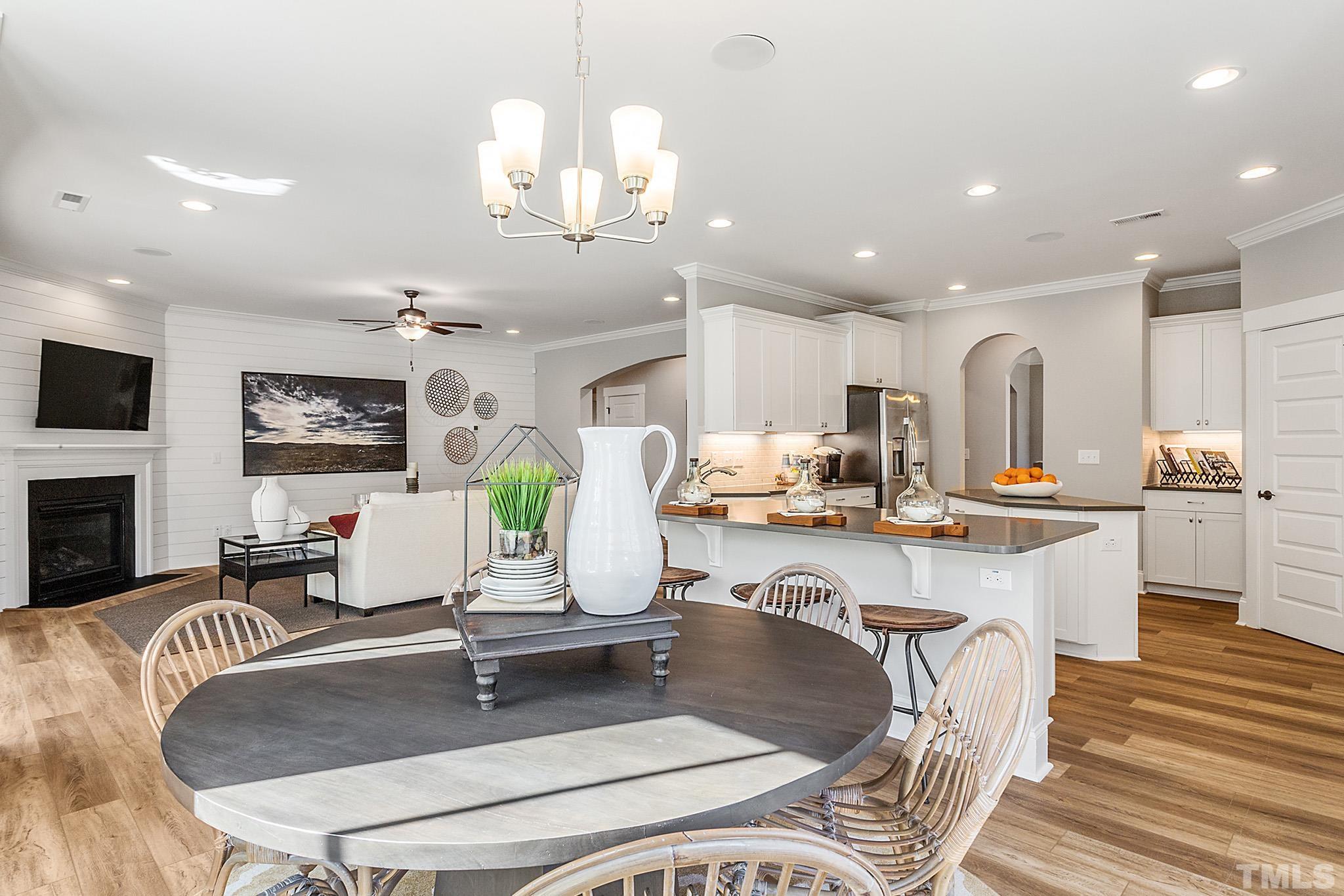 243 Oak Branch Trail Garner, NC 27529 - Photo 10 of 29 a living room with kitchen island furniture and a fireplace