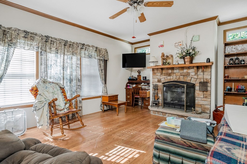 30211 White Oak Road Crawford, TN 38554 - Photo 11 of 24 a living room with furniture a flat screen tv and a fireplace
