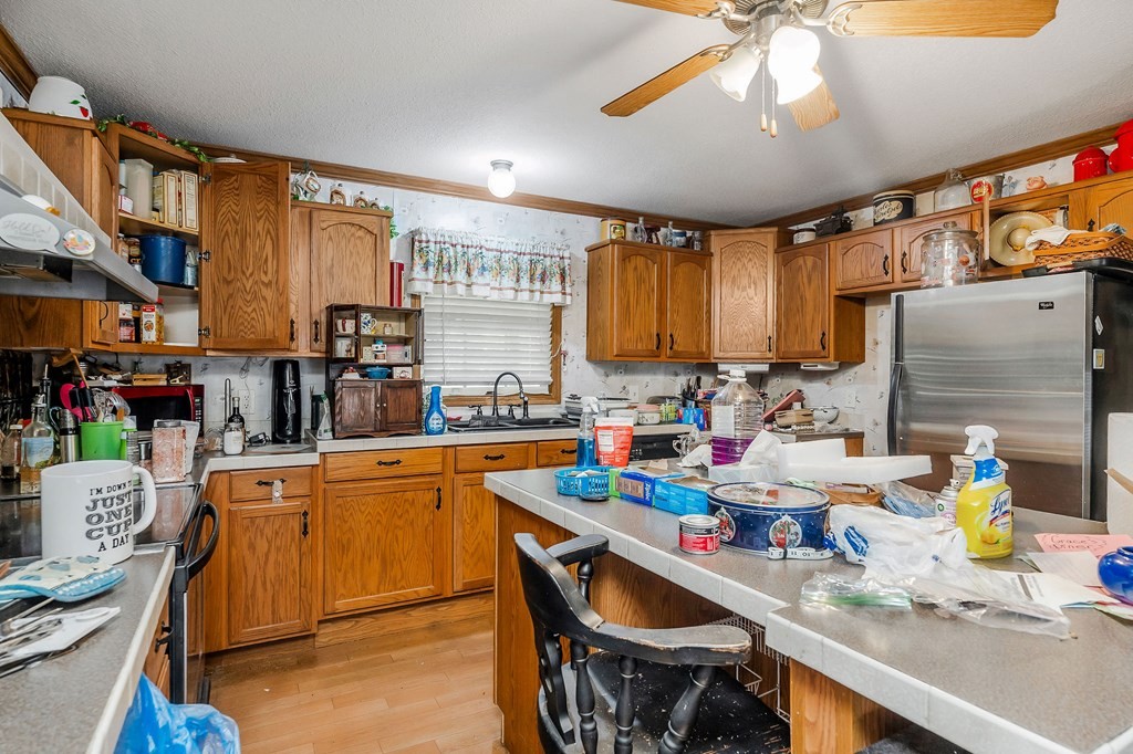 30211 White Oak Road Crawford, TN 38554 - Photo 13 of 24 a kitchen with stainless steel appliances granite countertop a sink dishwasher stove top oven and cabinets