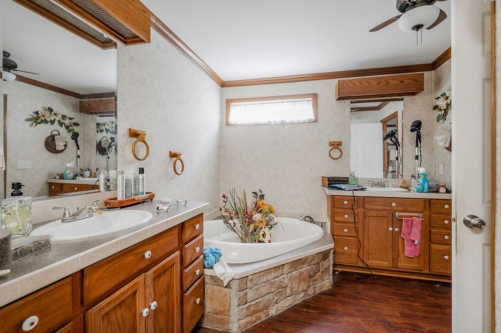30211 White Oak Road Crawford, TN 38554 - Photo 17 of 24 a spacious bathroom with a double vanity sink and a mirror