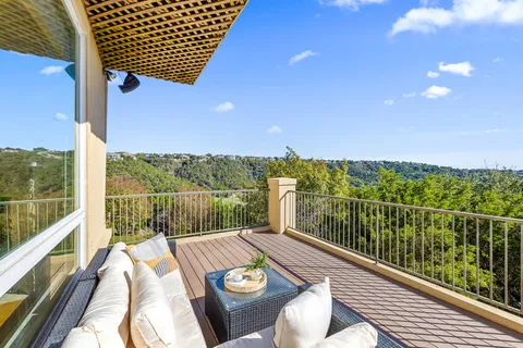 a view of balcony with furniture