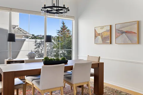 a view of a dining room with furniture and chandelier