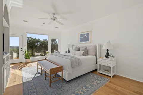 a bedroom with a bed and a large window