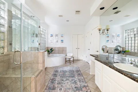 a large spacious bathroom with a granite countertop tub sink and mirror