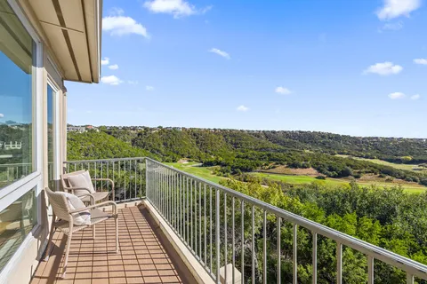 a view of a balcony with couches and wooden floor