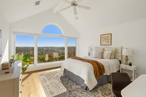 a bed sitting in a bedroom next to a window