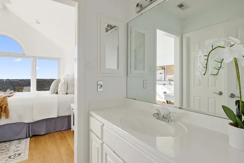 a bathroom with a tub sink and mirror