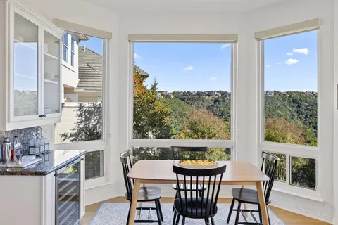 a view of a dining room with furniture window and outside view