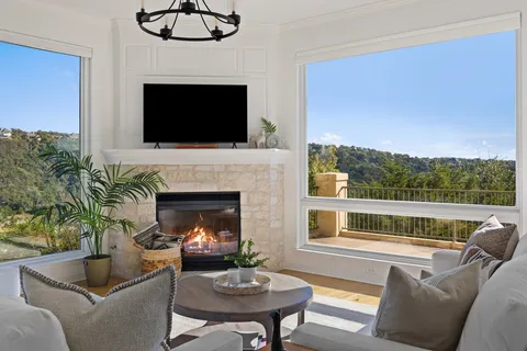 a living room with furniture a flat screen tv and a fireplace