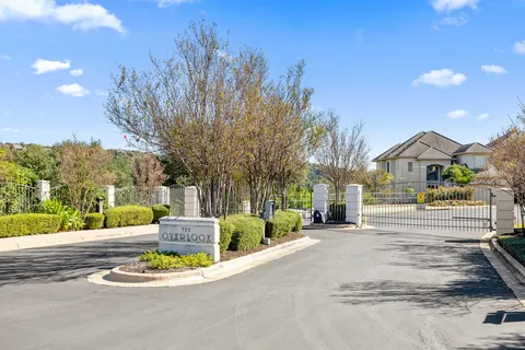 a view of a house with a big yard and potted plants