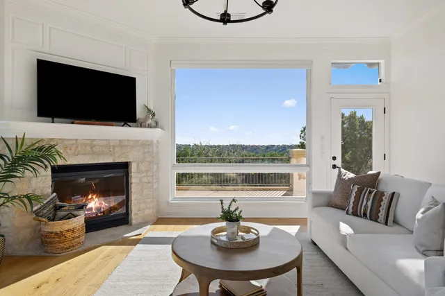 a living room with furniture a flat screen tv and a fireplace