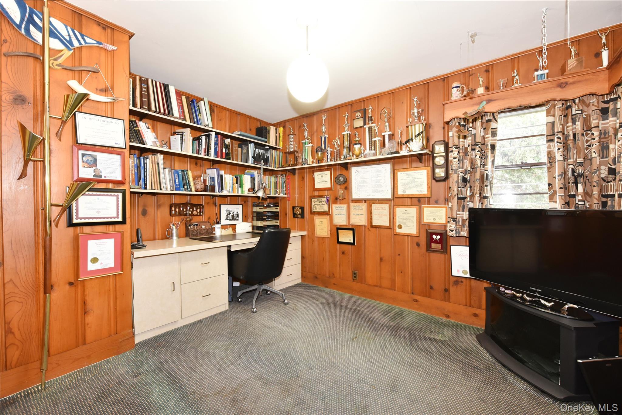 217-49 Stewart Road Queens, NY 11364 - Photo 19 of 27 a room with furniture and a flat screen tv