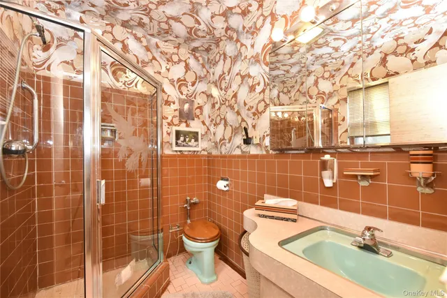 a bathroom with a granite countertop bathtub sink and toilet