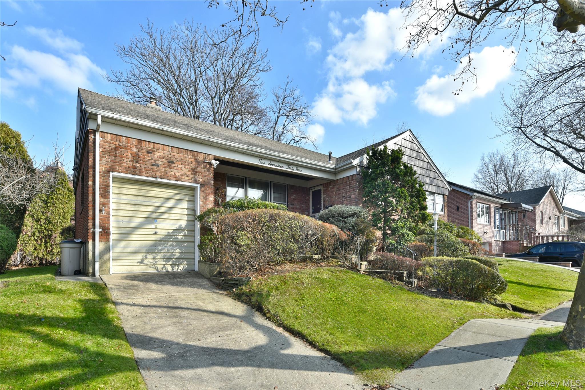 217-49 Stewart Road Queens, NY 11364 - Photo 3 of 27 a front view of a house with garden