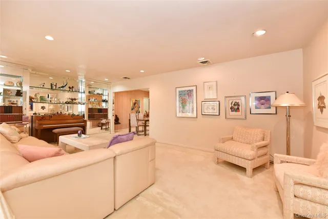 a living room with stainless steel appliances kitchen island granite countertop furniture and a view of living room