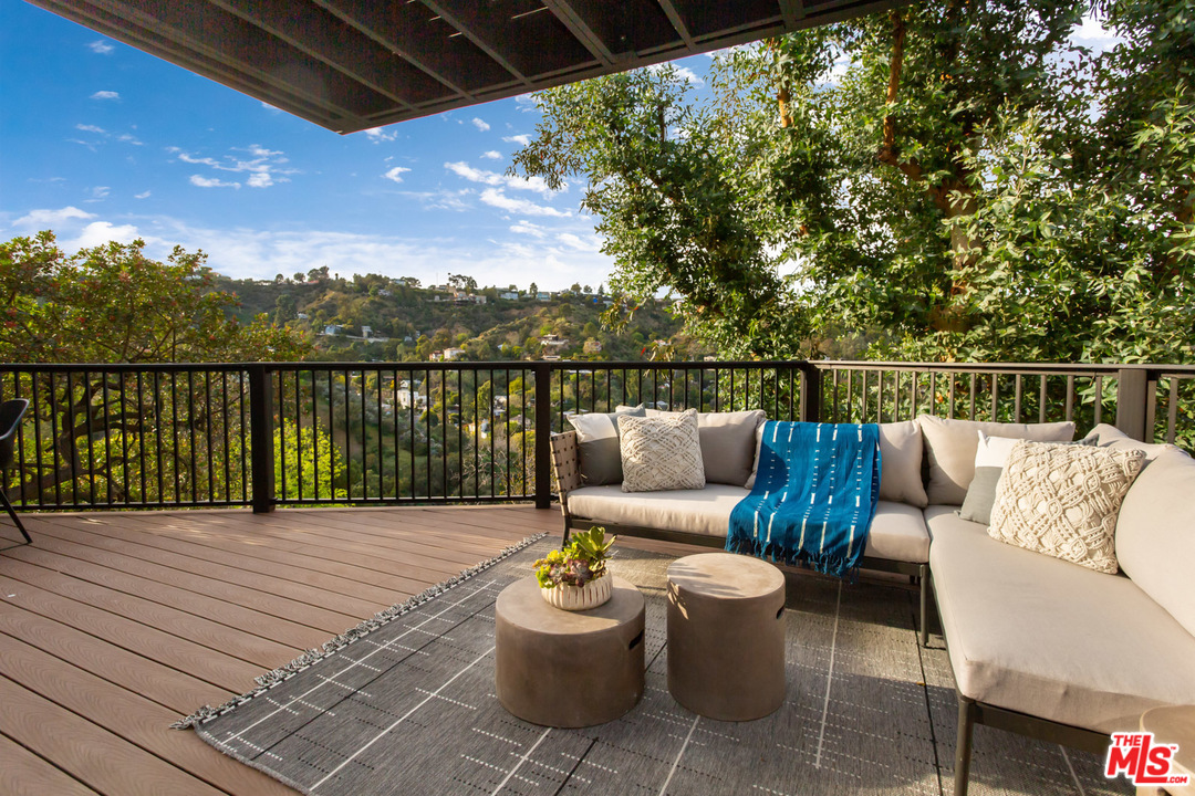 8321 Grand View Drive Los Angeles, CA 90046 - Photo 14 of 28 a view of a patio with couches chairs and wooden floor
