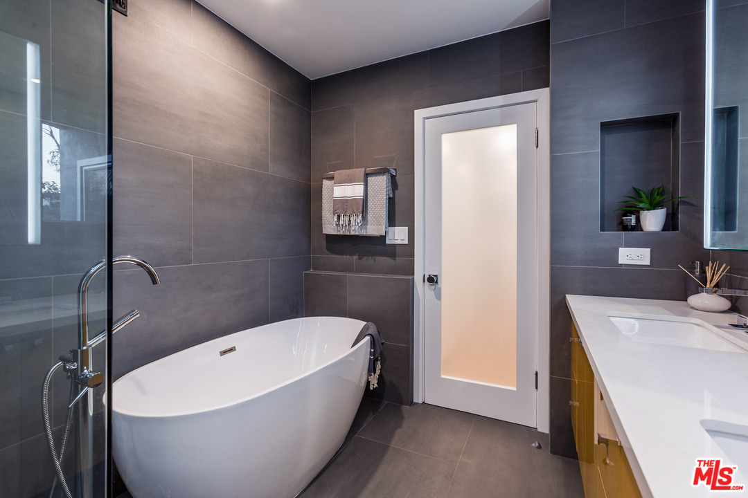 8321 Grand View Drive Los Angeles, CA 90046 - Photo 21 of 28 a bathroom with a bathtub and shower