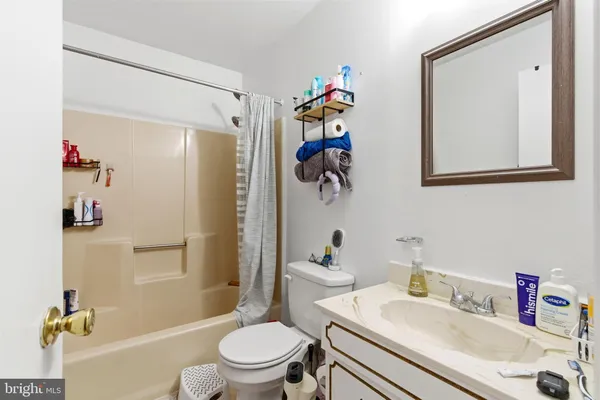 a bathroom with a sink mirror vanity and toilet