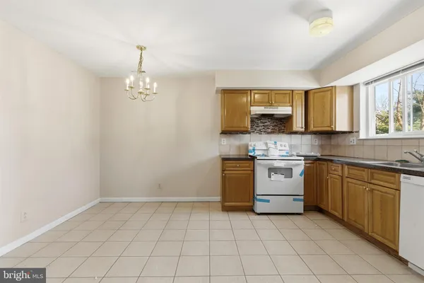 a kitchen with a sink cabinets and window