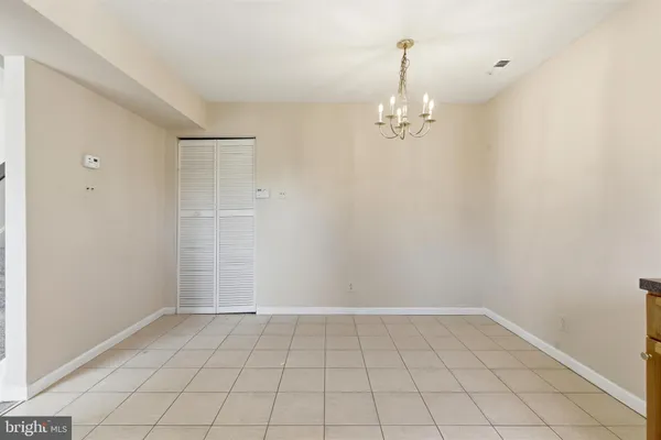a view of an empty room with chandelier