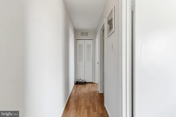 a view of a hallway with wooden floor