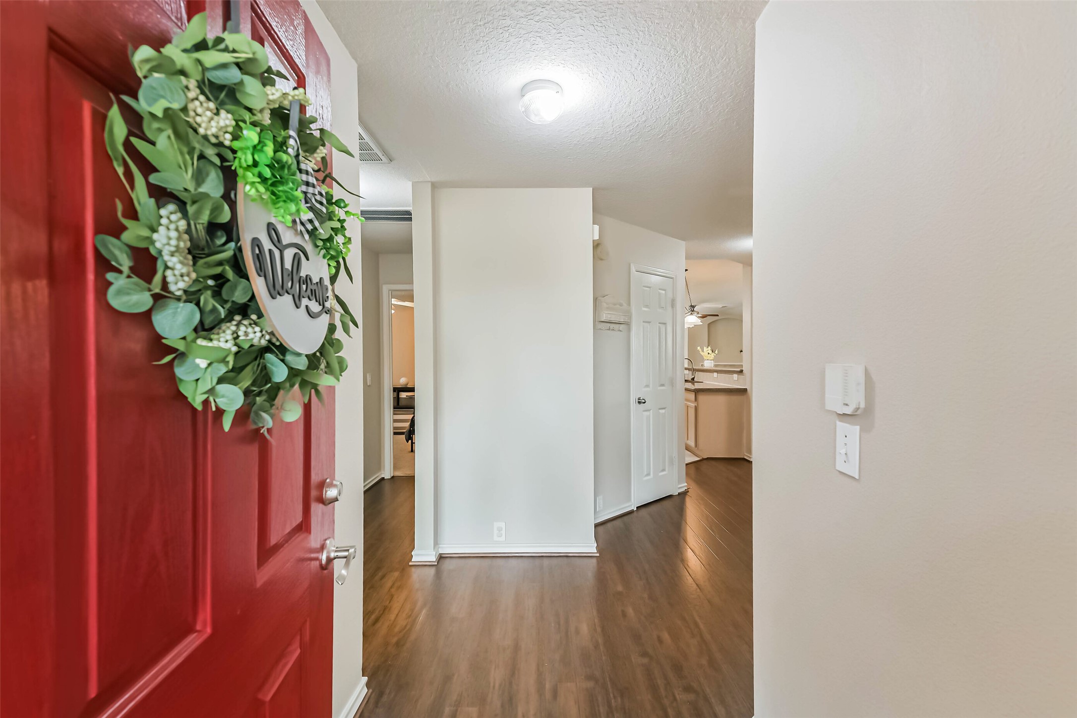 18239 Trinity Knoll Way Humble, TX 77346 - Photo 11 of 38 a view of a hallway with wooden floor and plant in a room