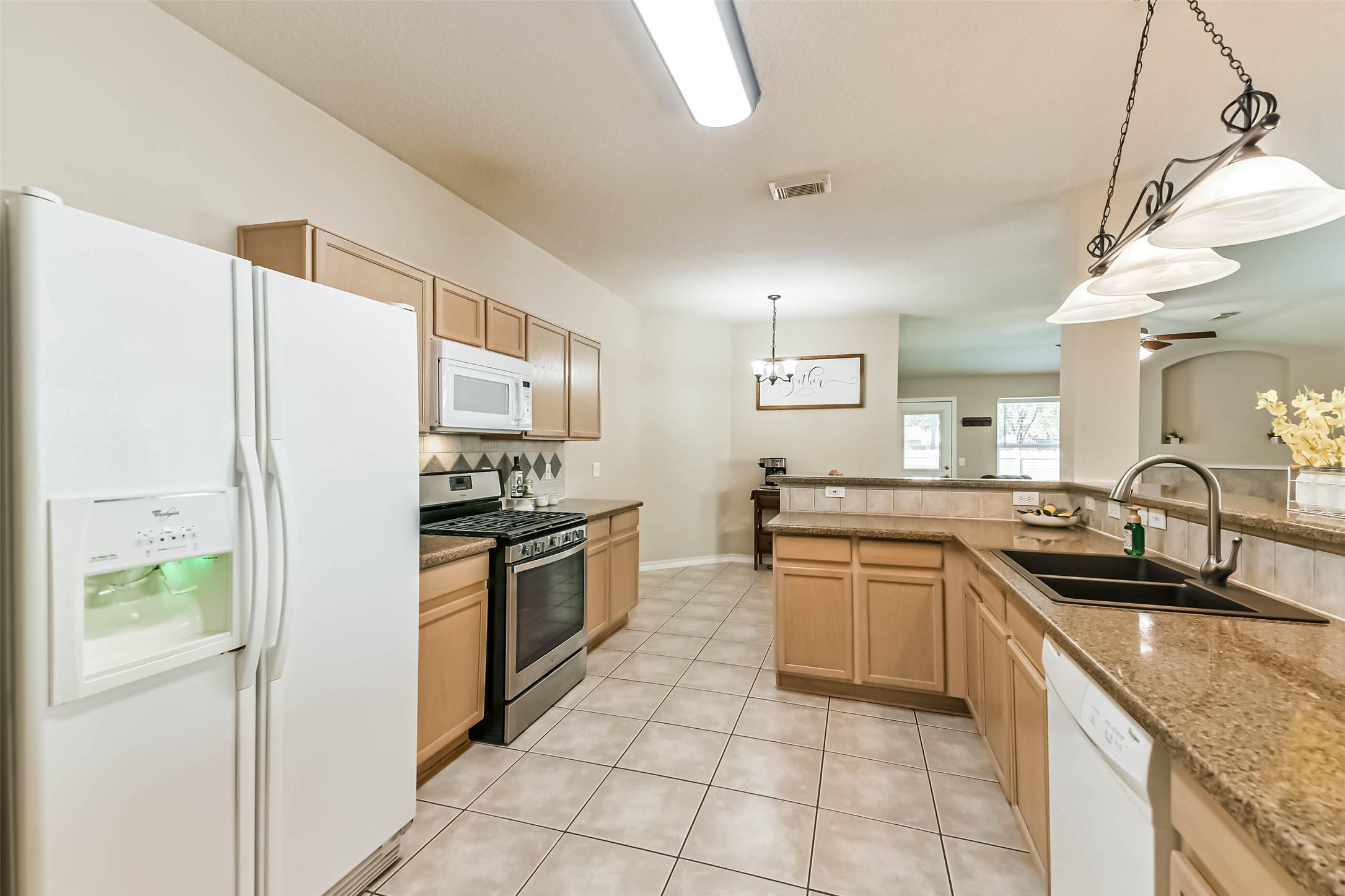 18239 Trinity Knoll Way Humble, TX 77346 - Photo 14 of 38 a kitchen with a sink stove and refrigerator