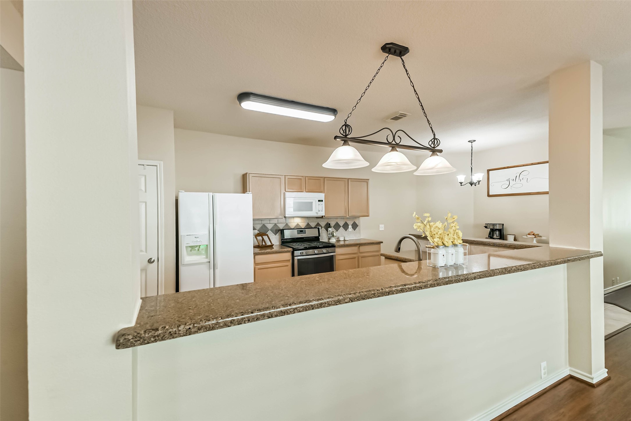 18239 Trinity Knoll Way Humble, TX 77346 - Photo 17 of 38 a kitchen with granite countertop a sink a counter top space and cabinets