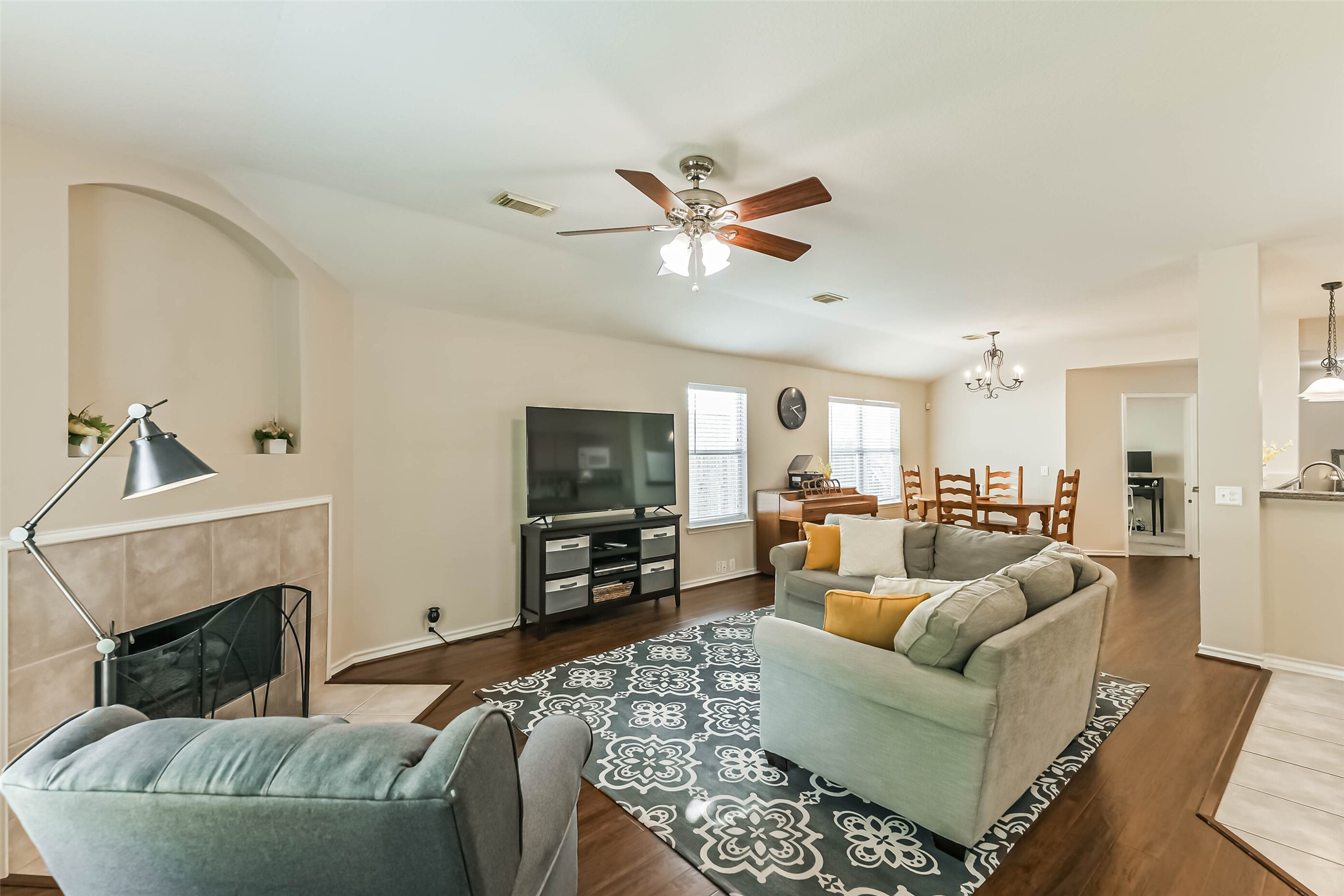 18239 Trinity Knoll Way Humble, TX 77346 - Photo 19 of 38 a living room with furniture a fireplace and a flat screen tv