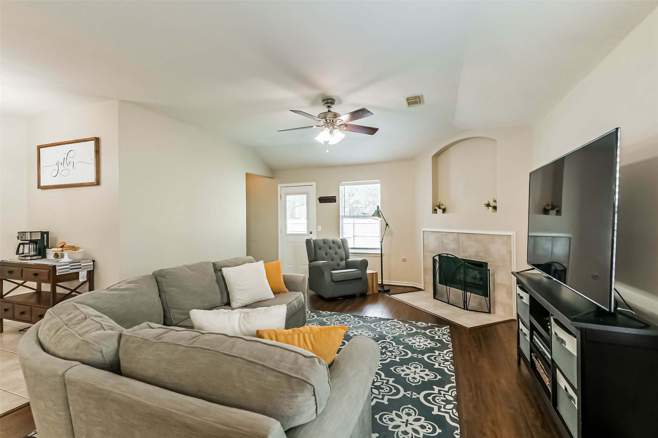 18239 Trinity Knoll Way Humble, TX 77346 - Photo 2 of 38 a living room with furniture fireplace and a flat screen tv