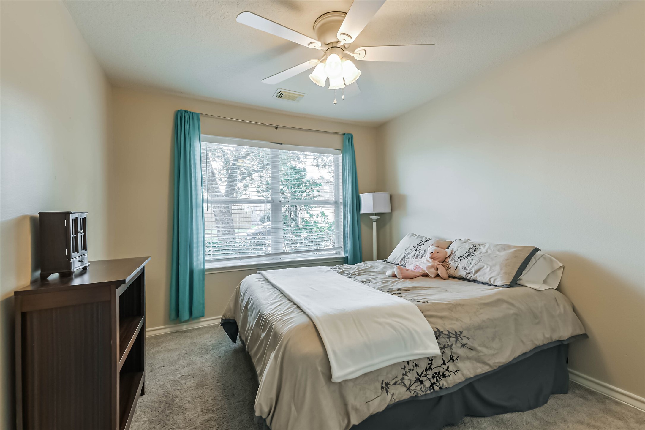 18239 Trinity Knoll Way Humble, TX 77346 - Photo 24 of 38 a bedroom with a bed desk and a window