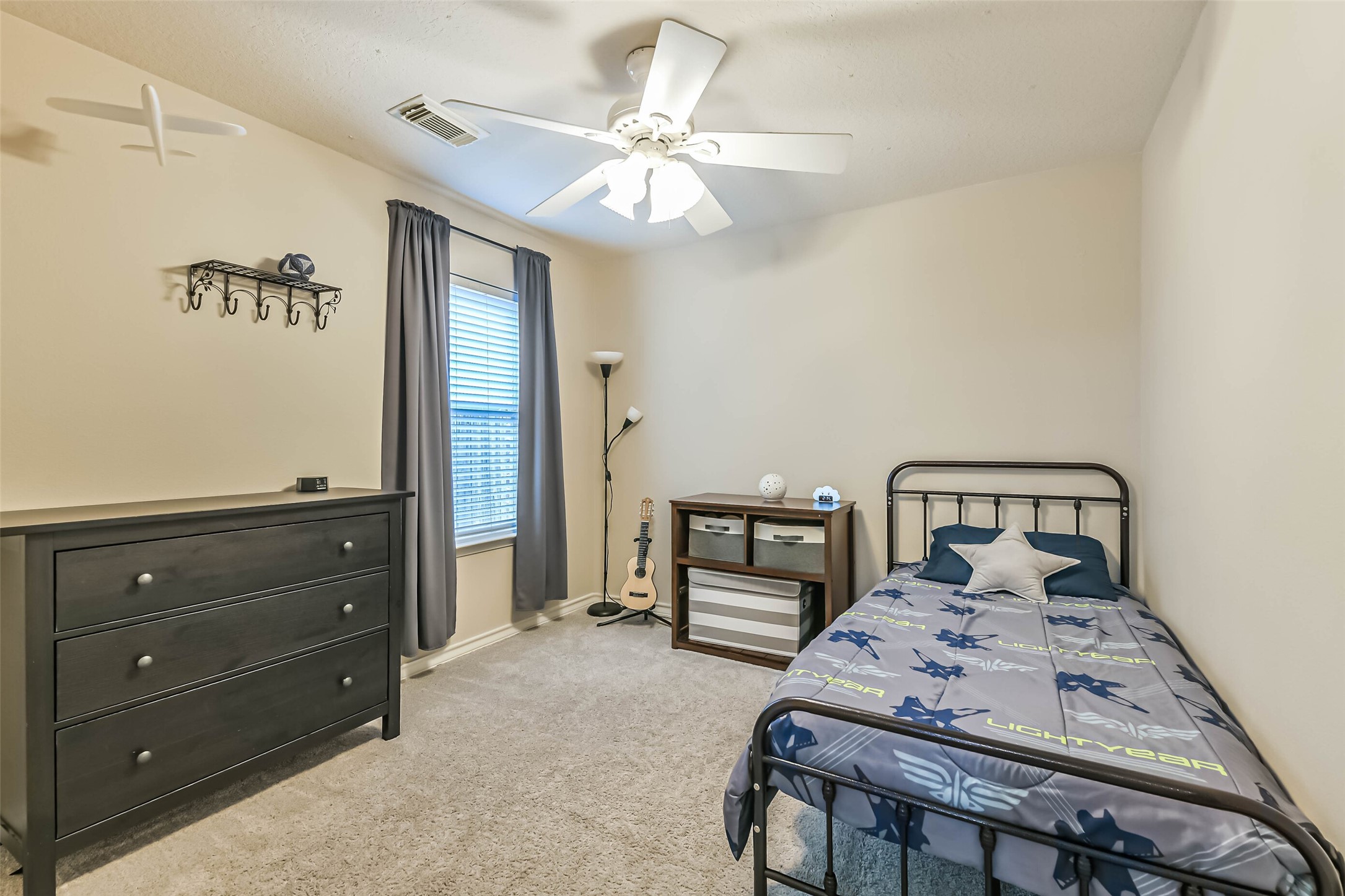 18239 Trinity Knoll Way Humble, TX 77346 - Photo 27 of 38 a bedroom with a bed and a chandelier