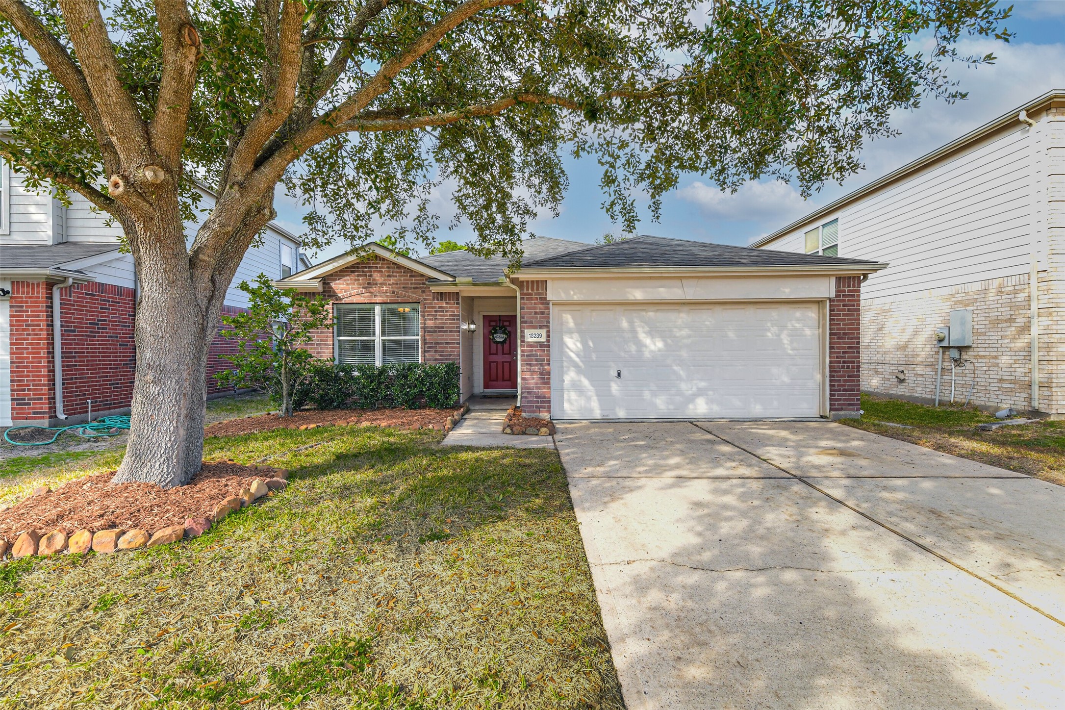 18239 Trinity Knoll Way Humble, TX 77346 - Photo 7 of 38 a front view of a house with a yard and garage