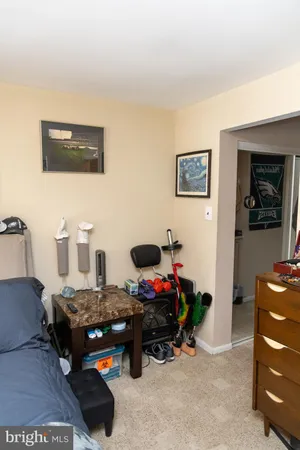 a living room with a couch and a dresser next to a window