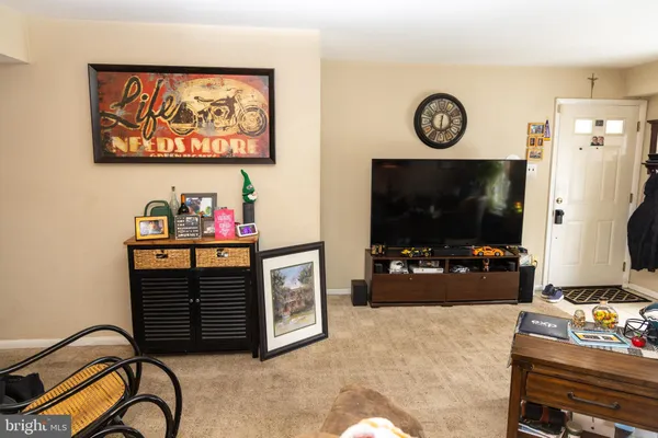 a kitchen with stainless steel appliances a sink a stove a refrigerator and cabinets