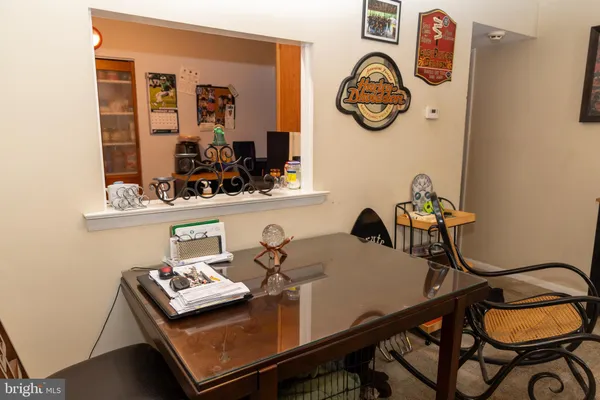 a view of a workspace with furniture and a window
