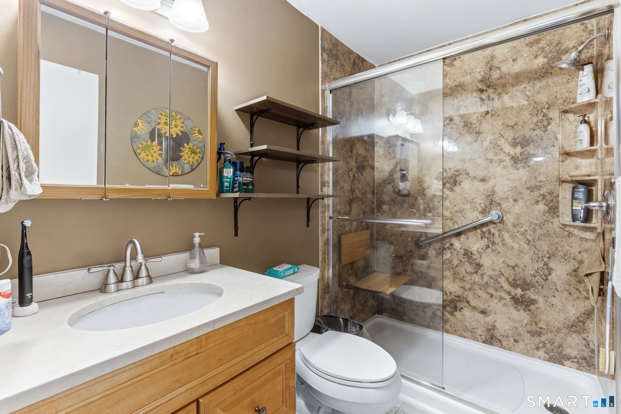 365 Mather Street, Unit 128 Hamden, CT 06514 - Photo 7 of 9 a bathroom with a sink a toilet and shower