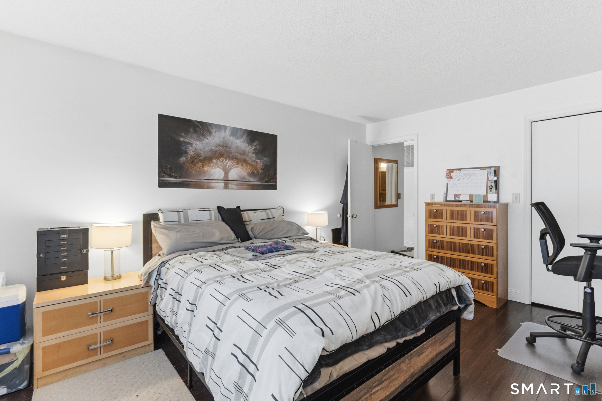 365 Mather Street, Unit 128 Hamden, CT 06514 - Photo 8 of 9 a bedroom with a bed and a flat screen tv